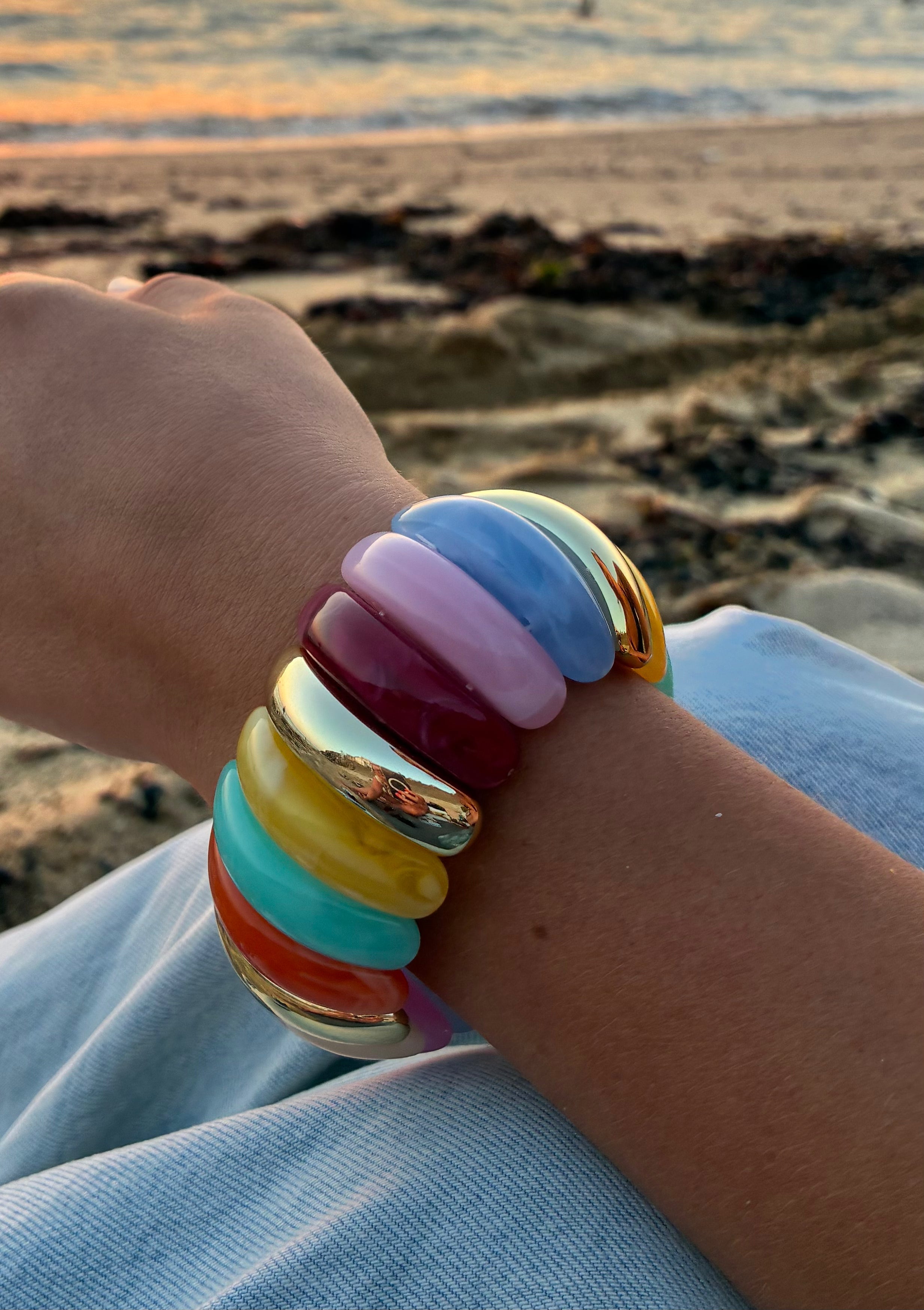 Bracelet multicolore en perles colorées, bracelet mode de la marque Le Vestiaire, porté sur une main.